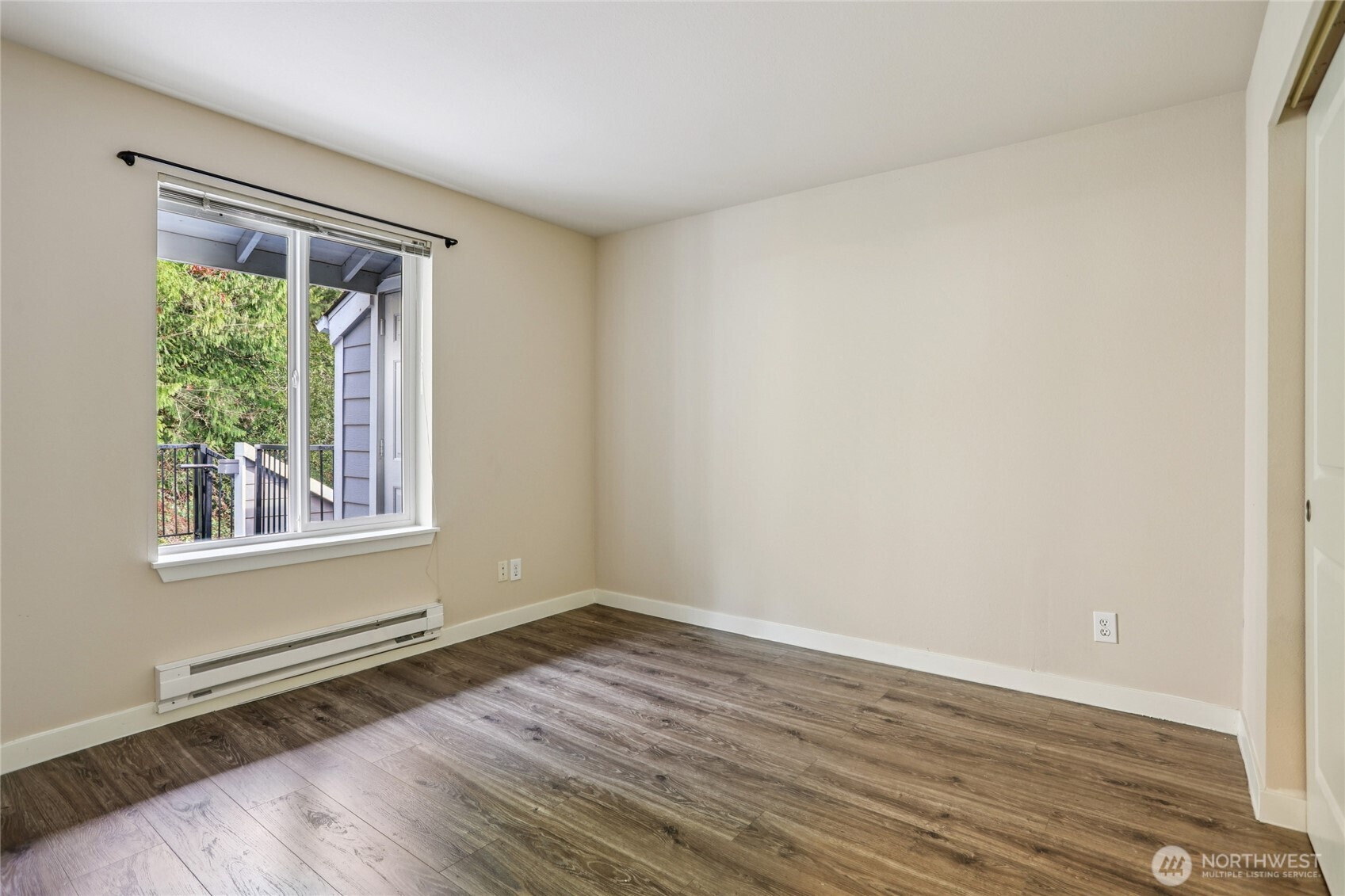 3927 243rd Place Southeast, Unit I304 Bothell, WA 98021 - Photo 19 of 28 a view of an empty room with wooden floor and a window