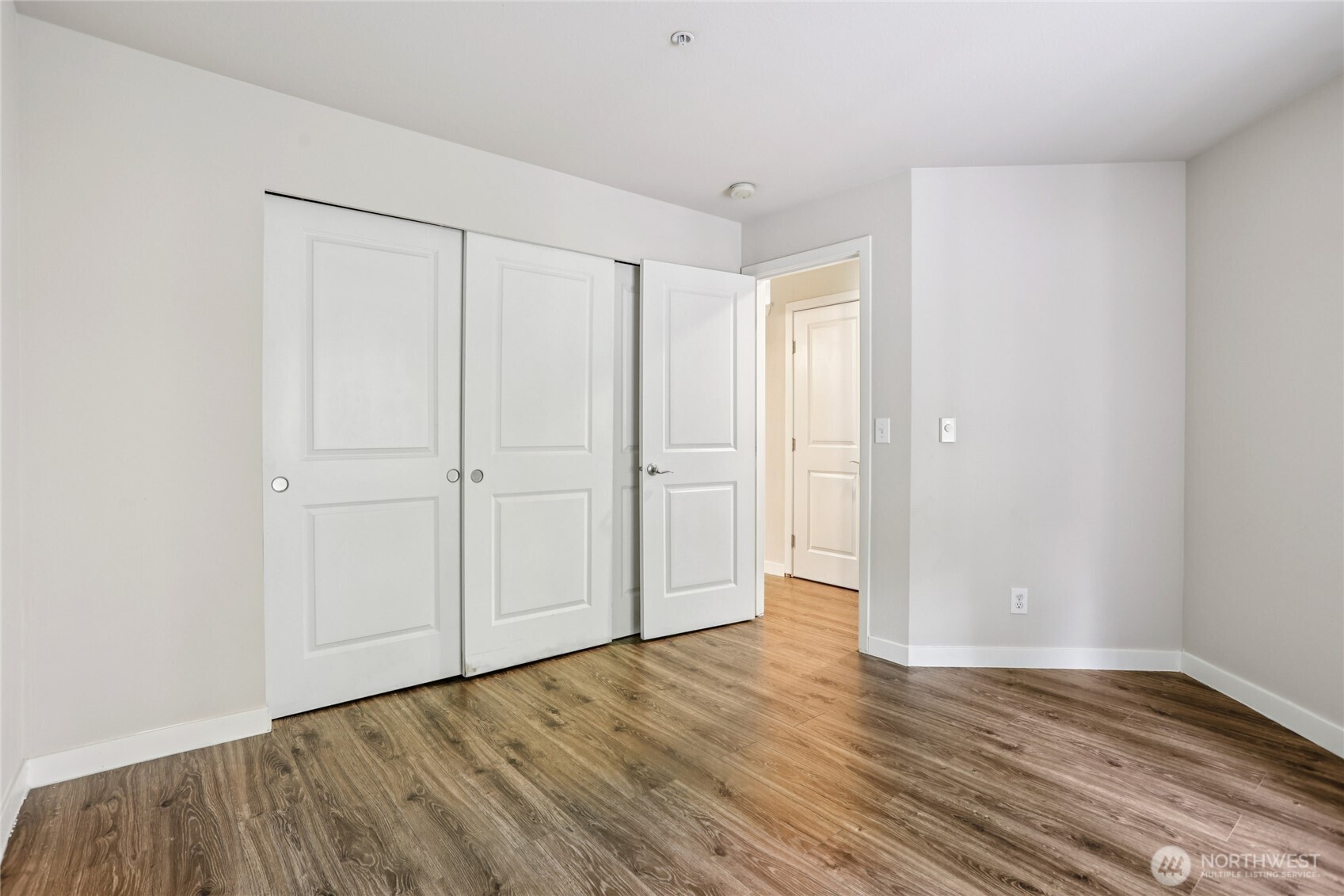 3927 243rd Place Southeast, Unit I304 Bothell, WA 98021 - Photo 20 of 28 a view of an empty room with wooden floor
