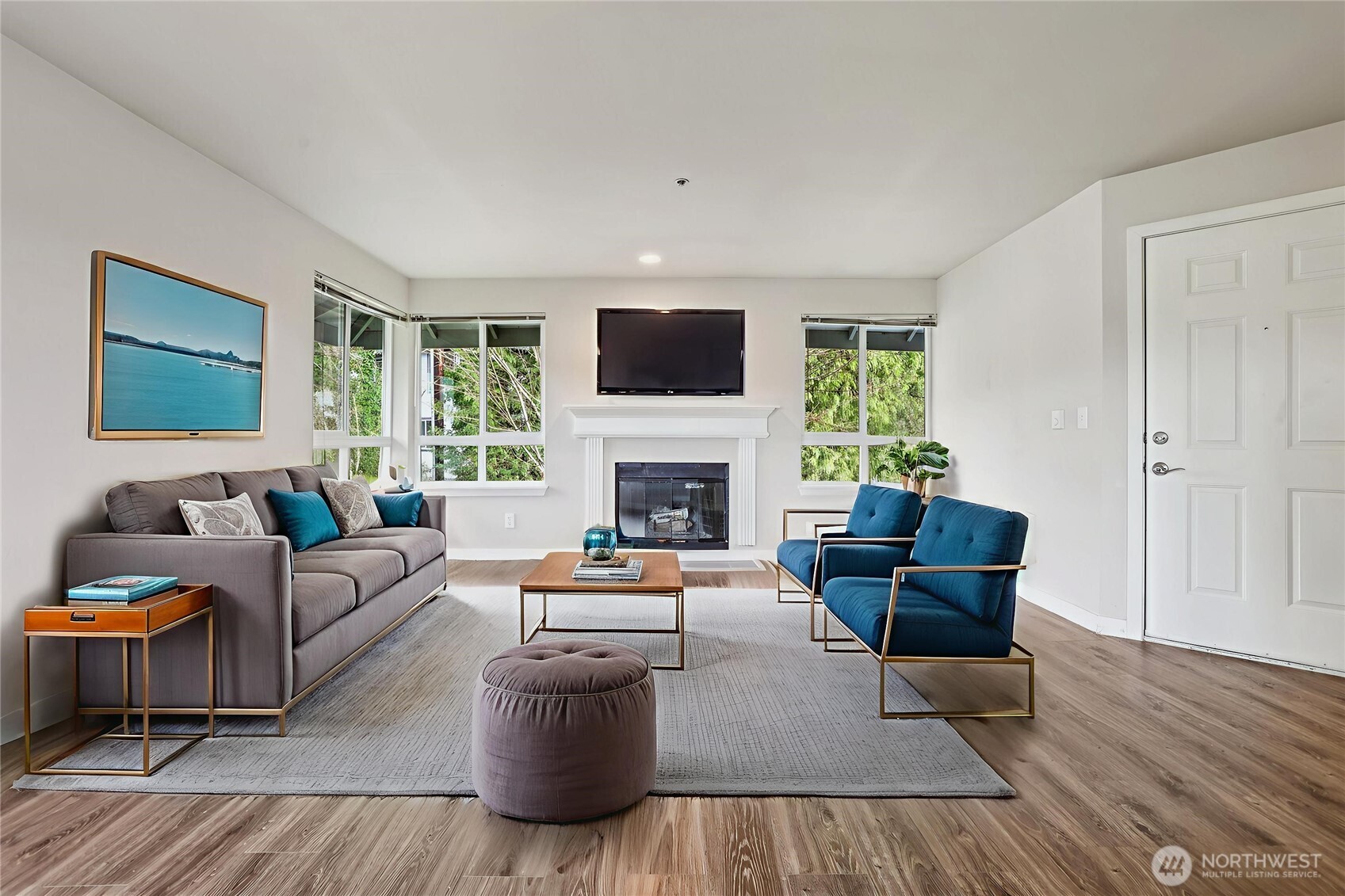 3927 243rd Place Southeast, Unit I304 Bothell, WA 98021 - Photo 5 of 28 a living room with furniture a flat screen tv and a fireplace