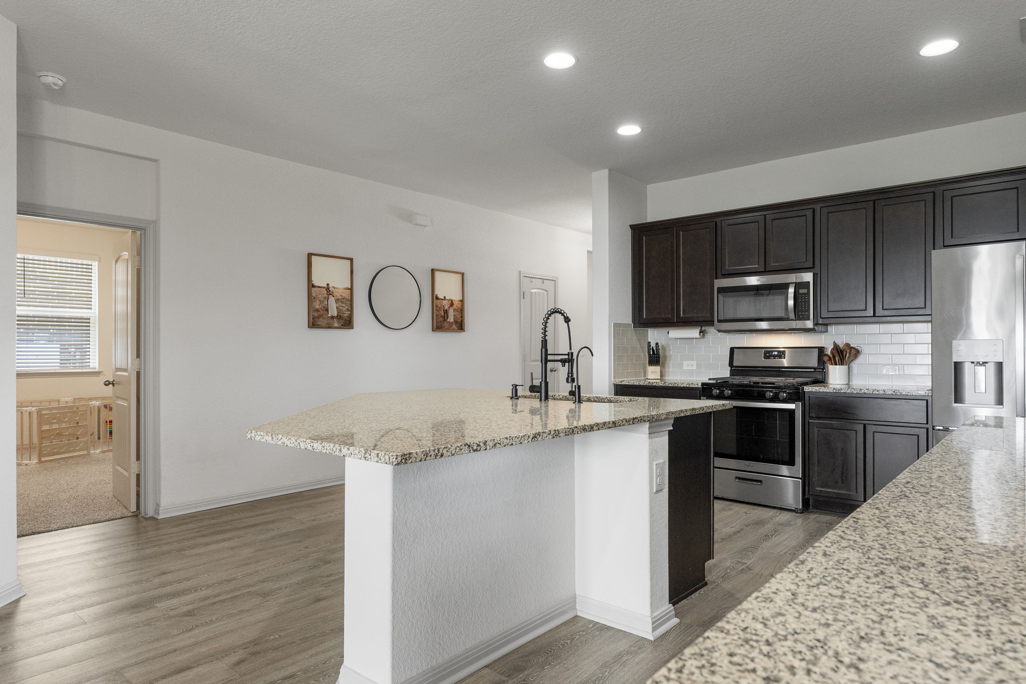 185 Struss Drive Georgetown, TX 78626 - Photo 6 of 23 A chef's dream kitchen, offering granite counters and a practical island, perfect for culinary creations and gatherings.