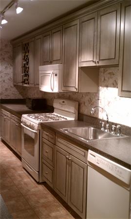 a kitchen with granite countertop cabinets stainless steel appliances and a sink