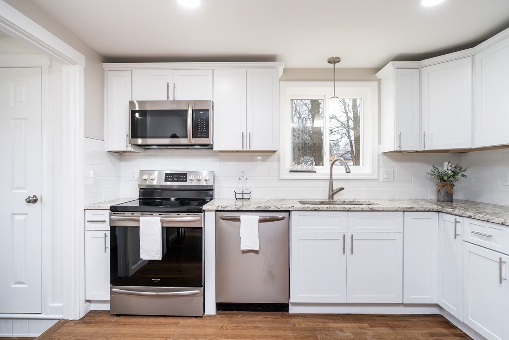 152 Shady Brook Lane Springfield, MA 01118 - Photo 1 of 26 a kitchen with stainless steel appliances granite countertop a stove a sink and a microwave