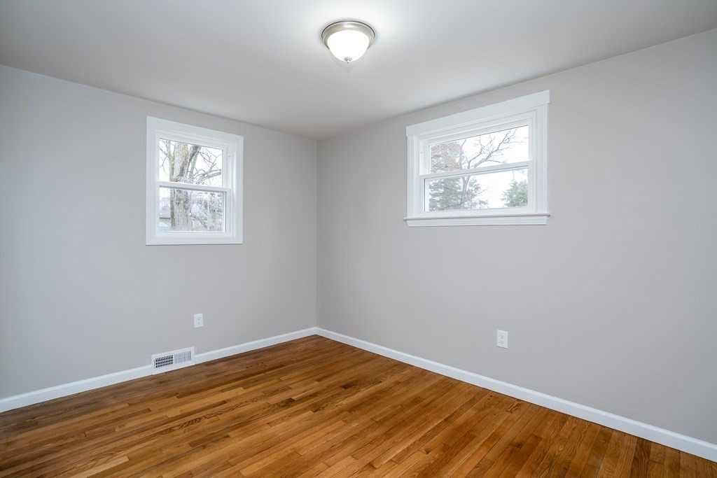 152 Shady Brook Lane Springfield, MA 01118 - Photo 14 of 26 a view of an empty room with wooden floor and a window