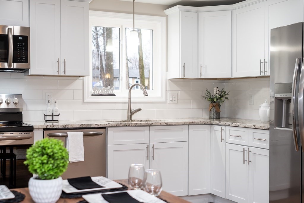 152 Shady Brook Lane Springfield, MA 01118 - Photo 2 of 26 a kitchen with a white cabinets and window