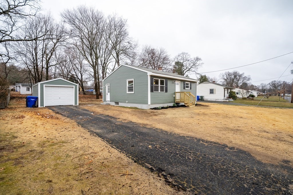 152 Shady Brook Lane Springfield, MA 01118 - Photo 22 of 26 a front view of a house with a yard and garage