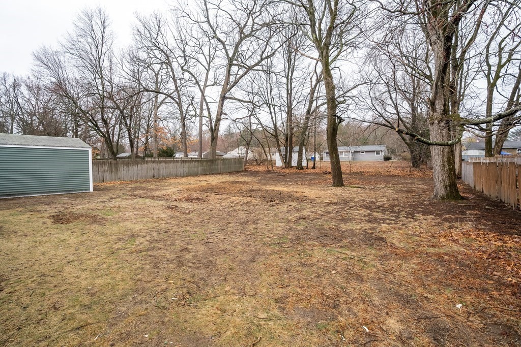 152 Shady Brook Lane Springfield, MA 01118 - Photo 25 of 26 a backyard of a house with large trees