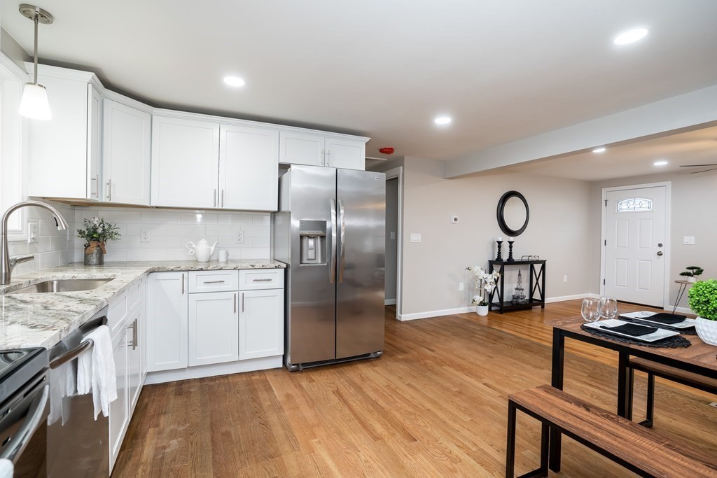 152 Shady Brook Lane Springfield, MA 01118 - Photo 3 of 26 a kitchen with stainless steel appliances granite countertop a sink a stove a refrigerator cabinets and a dining table