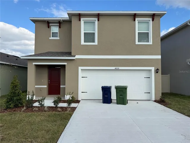 a front view of a house with garage