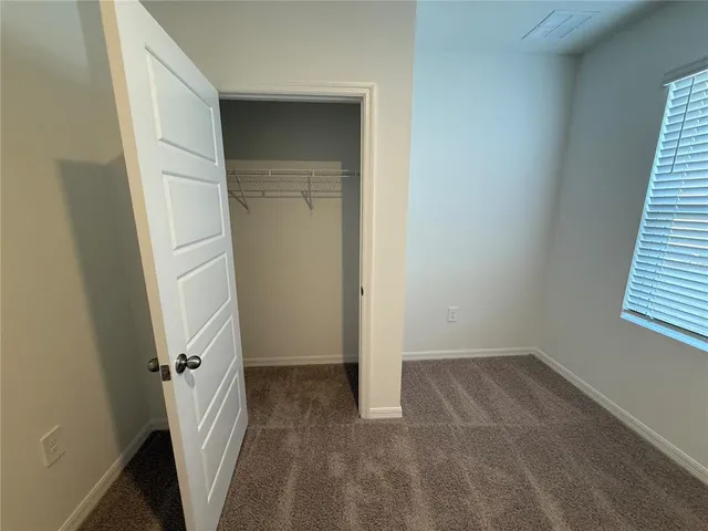 a view of a room with a wooden door