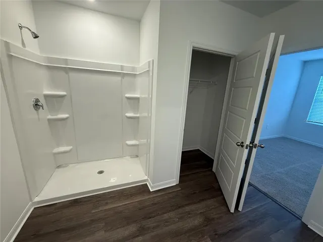 a bathroom with a bathtub and a shower