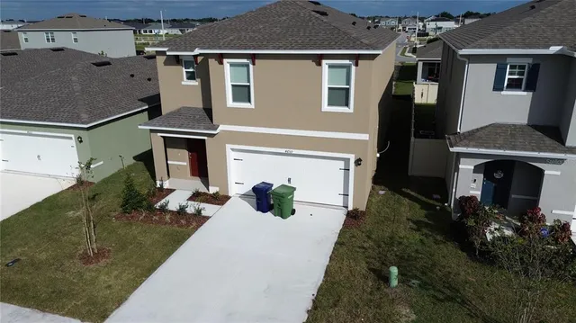 a front view of a house with parking space