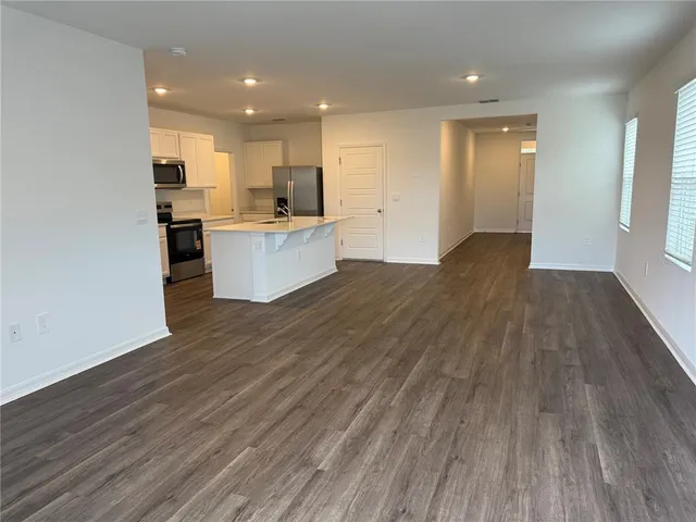 a view of kitchen and kitchen with wooden floor