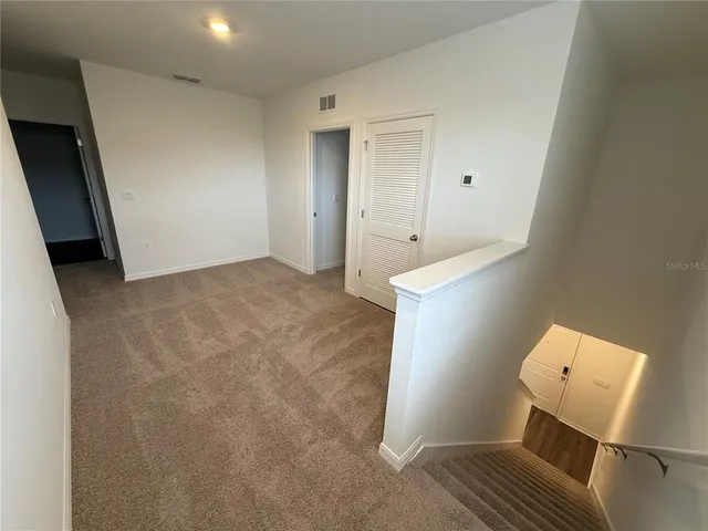 a view of room with wooden floor and chair