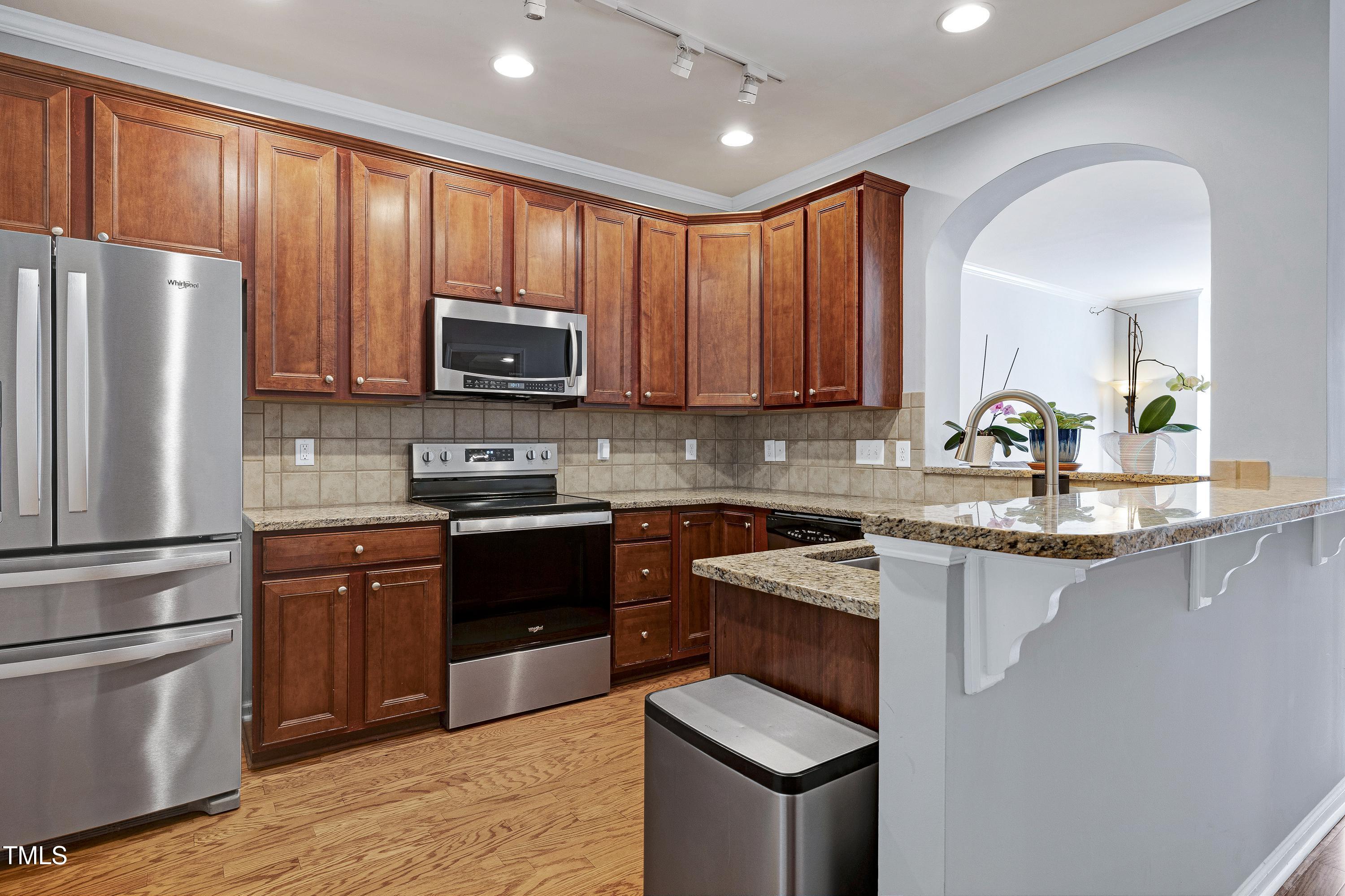 5809 Cameo Glass Way Raleigh, NC 27612 - Photo 14 of 43 Rich cabinetry and stainless appliances