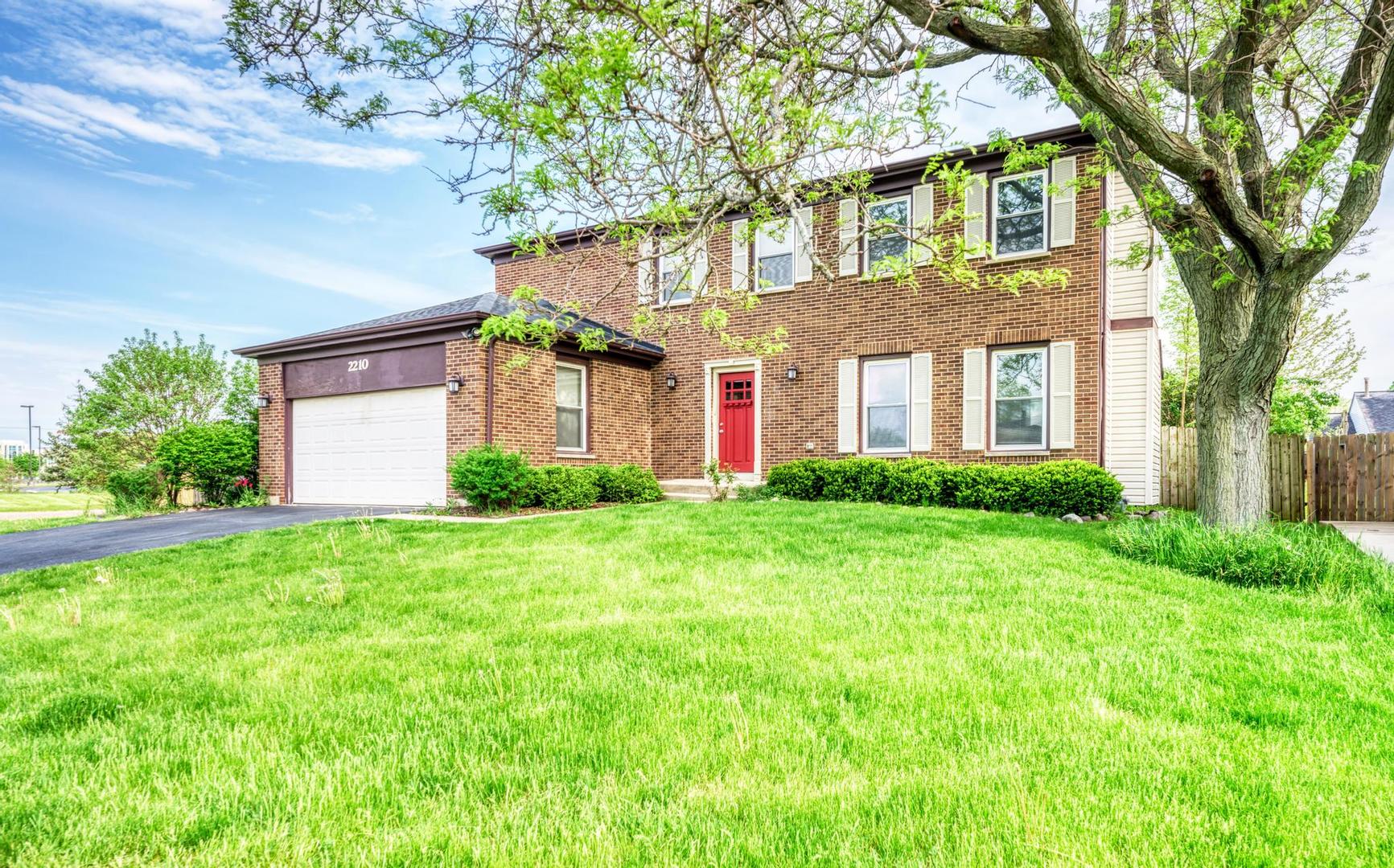 2210 Ridge Avenue Aurora, IL 60504 - Photo 1 of 29 a front view of a house with garden and trees