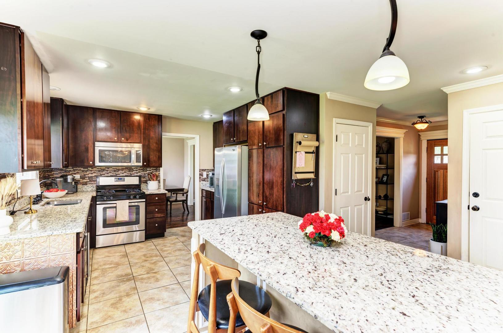 2210 Ridge Avenue Aurora, IL 60504 - Photo 11 of 29 a kitchen with kitchen island a sink stove and refrigerator