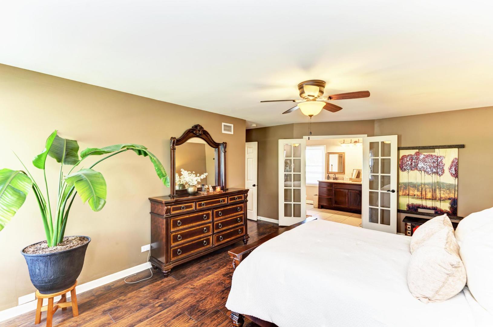 2210 Ridge Avenue Aurora, IL 60504 - Photo 18 of 29 a bedroom with a bed and a chandelier