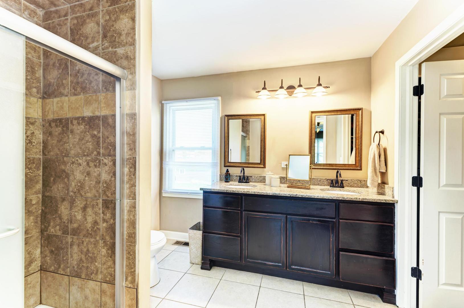 2210 Ridge Avenue Aurora, IL 60504 - Photo 19 of 29 a bathroom with a double vanity sink and a mirror