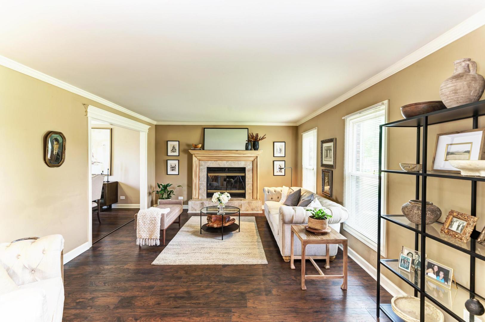 2210 Ridge Avenue Aurora, IL 60504 - Photo 2 of 29 a living room with furniture large window and a fireplace