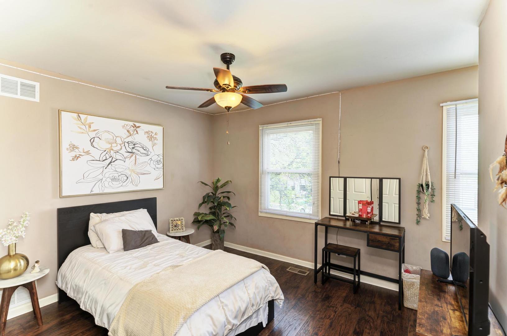 2210 Ridge Avenue Aurora, IL 60504 - Photo 22 of 29 a bedroom with a bed table chair and a window