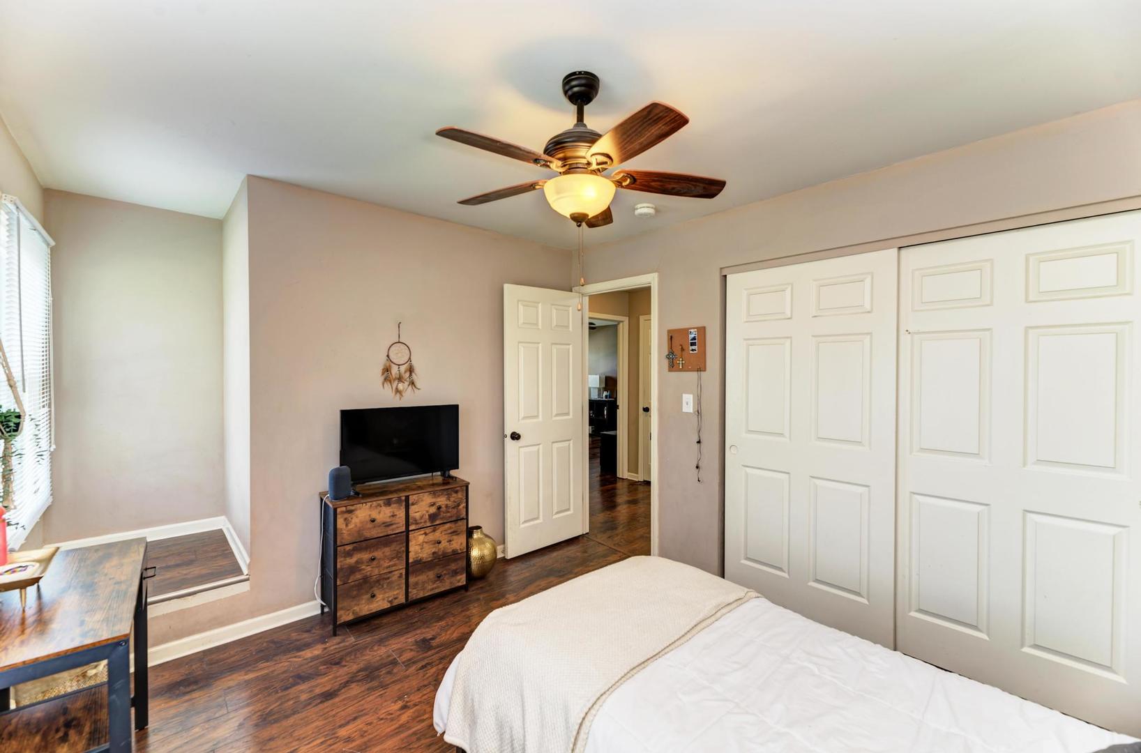 2210 Ridge Avenue Aurora, IL 60504 - Photo 23 of 29 a bedroom with a bed and a chandelier