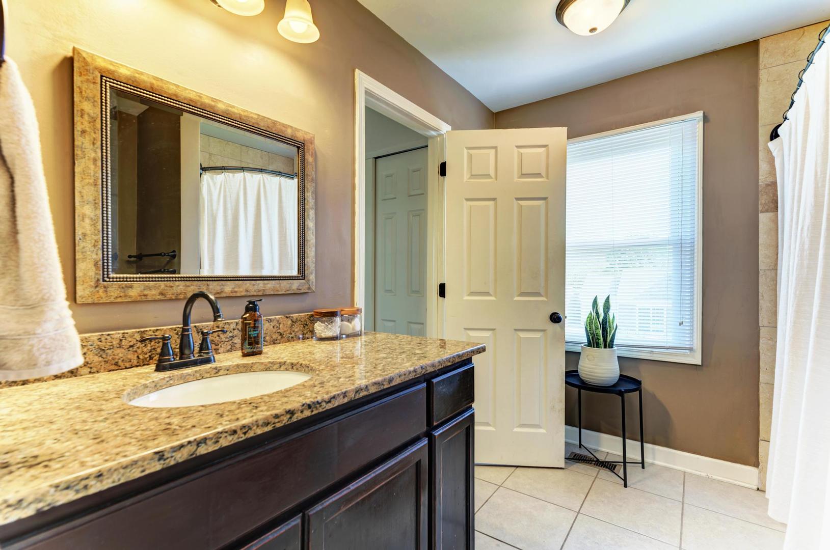 2210 Ridge Avenue Aurora, IL 60504 - Photo 24 of 29 a bathroom with a granite countertop sink and a mirror