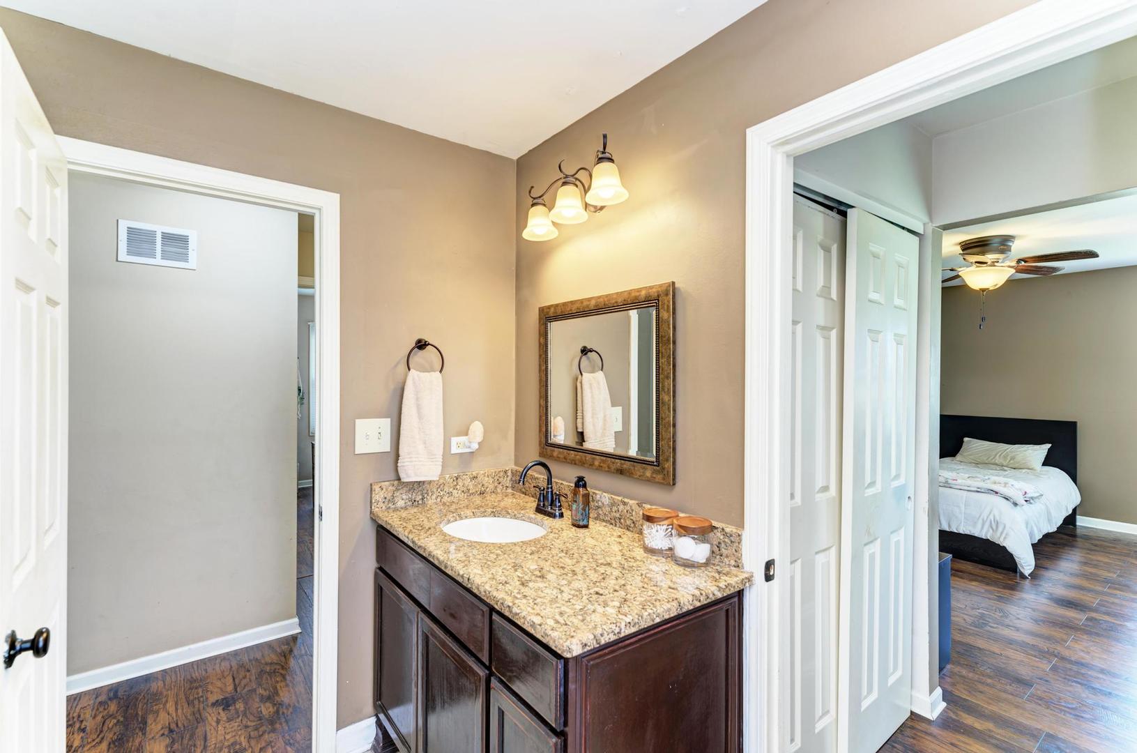 2210 Ridge Avenue Aurora, IL 60504 - Photo 25 of 29 a en suite bathroom with a granite countertop sink and a mirror