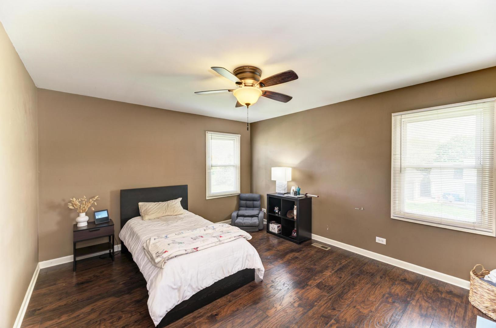 2210 Ridge Avenue Aurora, IL 60504 - Photo 26 of 29 a bedroom with a bed and a chandelier