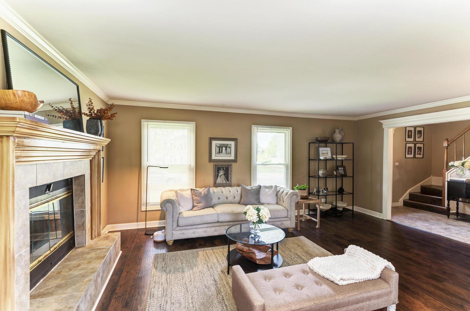 2210 Ridge Avenue Aurora, IL 60504 - Photo 4 of 29 a living room with furniture fireplace and a table