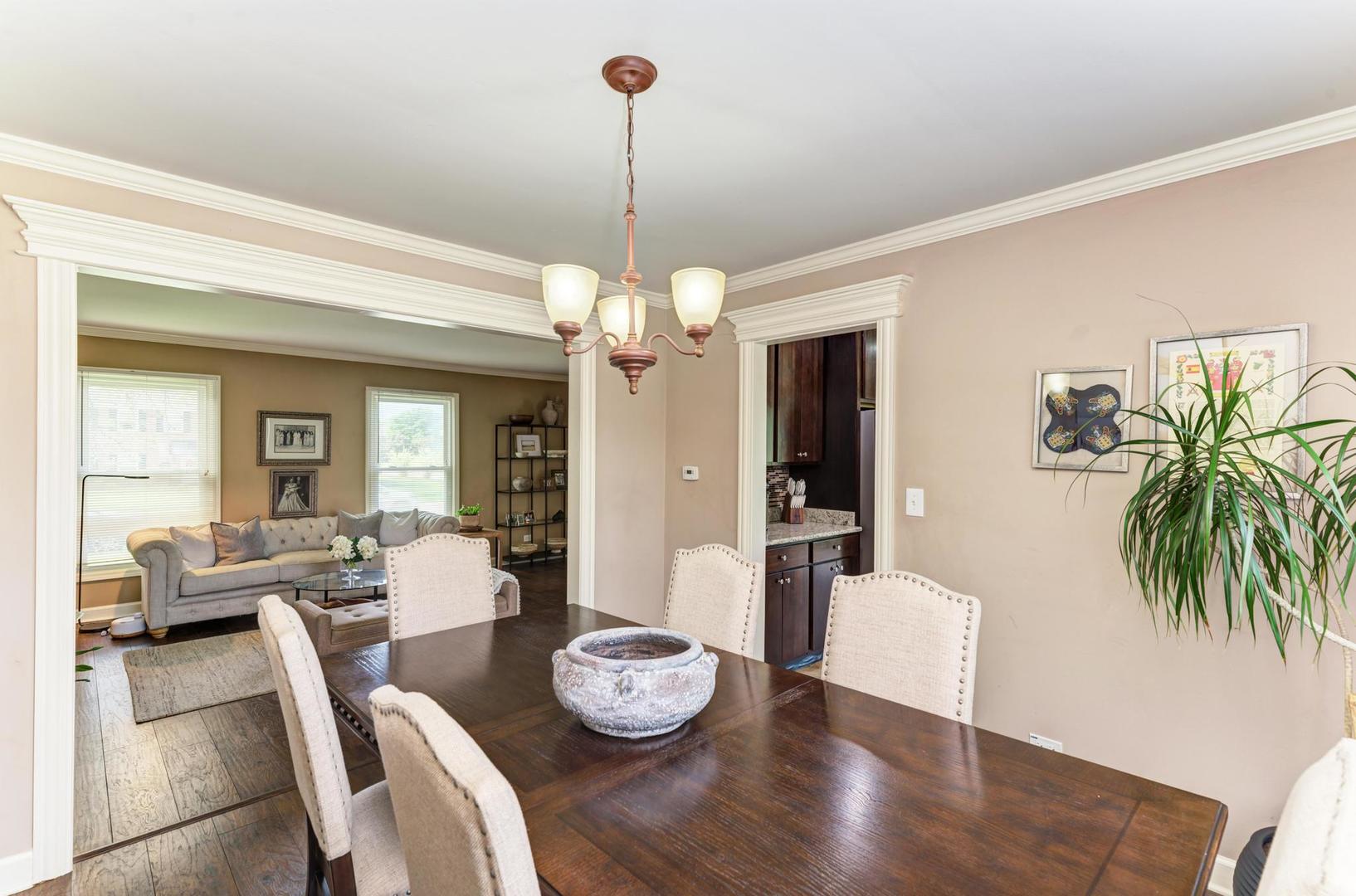 2210 Ridge Avenue Aurora, IL 60504 - Photo 6 of 29 a dining room with furniture a chandelier and wooden floor