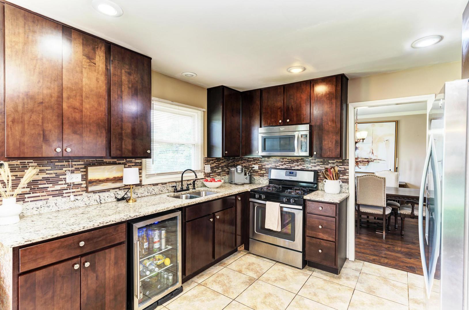 2210 Ridge Avenue Aurora, IL 60504 - Photo 8 of 29 a kitchen with stainless steel appliances granite countertop wooden cabinets a sink and dishwasher