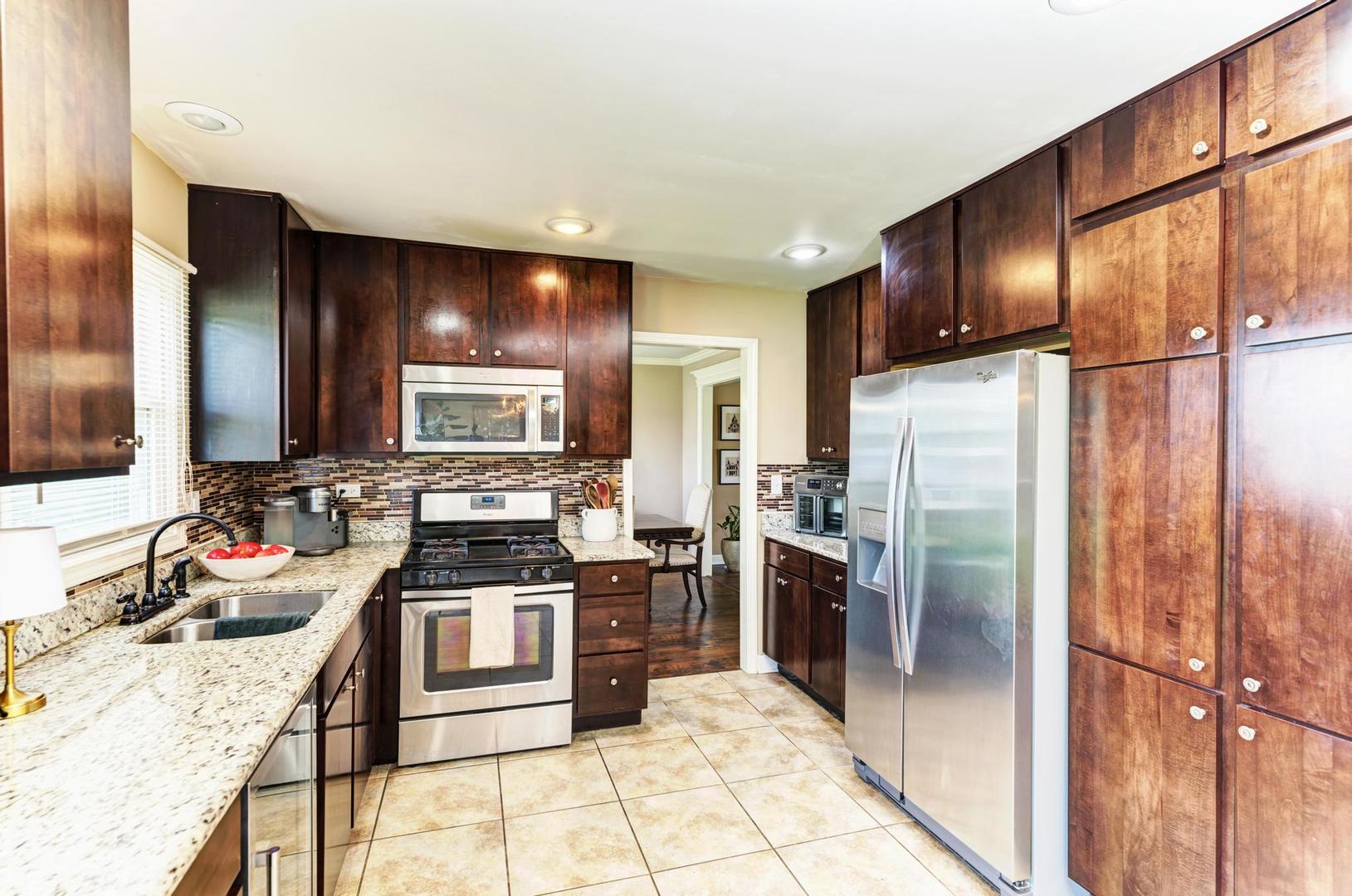 2210 Ridge Avenue Aurora, IL 60504 - Photo 9 of 29 a kitchen with stainless steel appliances granite countertop a refrigerator stove and oven