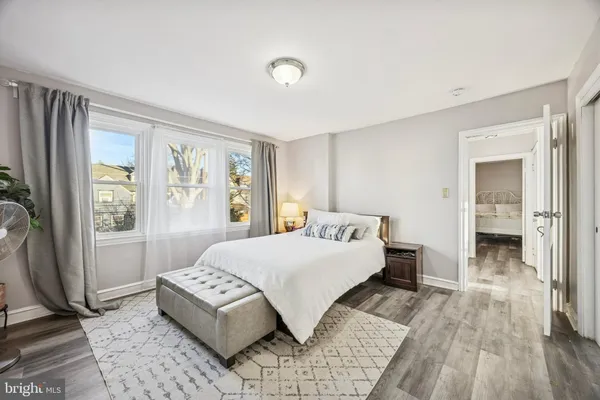 a bedroom with a large bed and a window