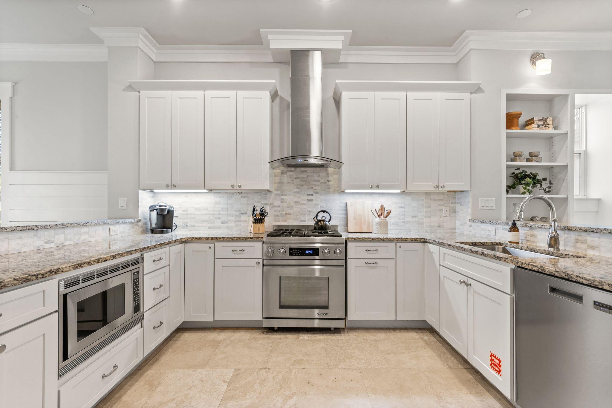 51 Trigger Trail East Inlet Beach, FL 32461 - Photo 13 of 57 a kitchen with stainless steel appliances granite countertop a stove sink and cabinets
