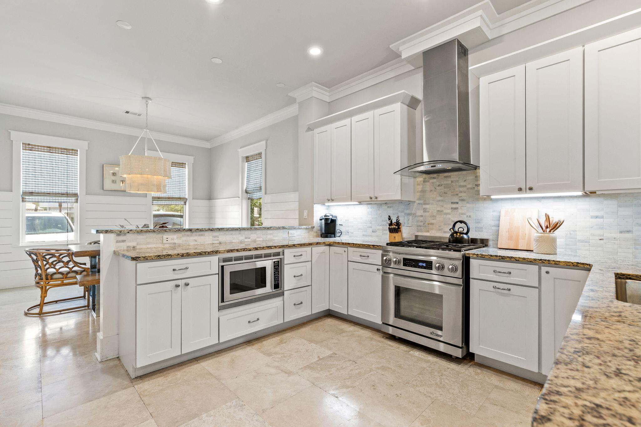 51 Trigger Trail East Inlet Beach, FL 32461 - Photo 14 of 57 a kitchen with granite countertop white cabinets and white stainless steel appliances