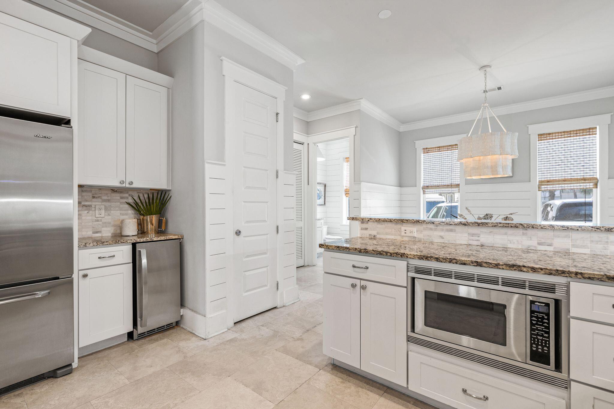 51 Trigger Trail East Inlet Beach, FL 32461 - Photo 15 of 57 a kitchen with white cabinets and stainless steel appliances