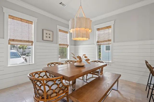 a view of a dining room with furniture and a chandelier