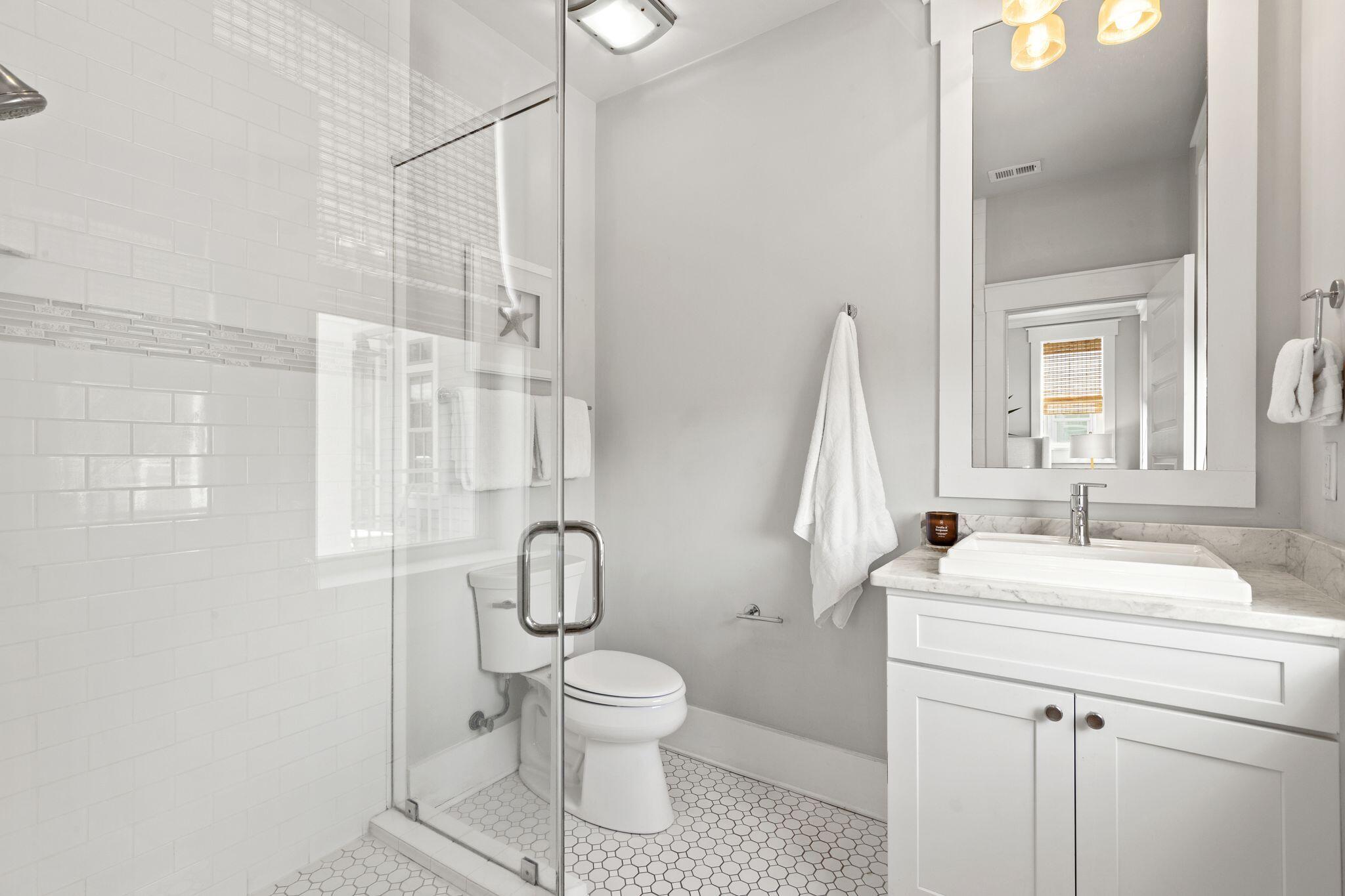 51 Trigger Trail East Inlet Beach, FL 32461 - Photo 23 of 57 a bathroom with a toilet sink and a mirror