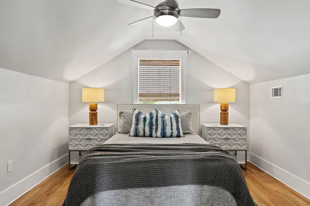 a bedroom with two beds and a window