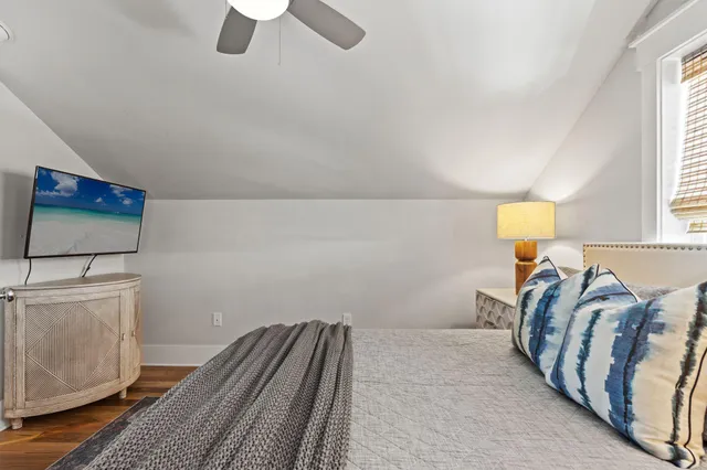 a bedroom with two beds and a chandelier
