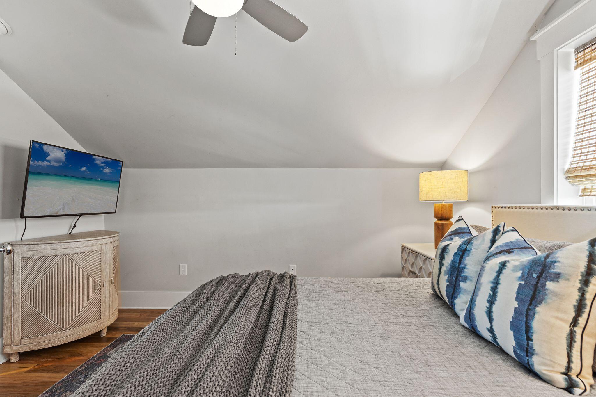 51 Trigger Trail East Inlet Beach, FL 32461 - Photo 37 of 57 a bedroom with a bed and a chandelier