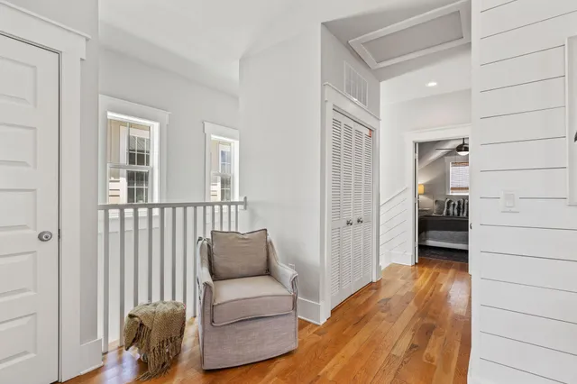 a living room with furniture and floor to ceiling windows