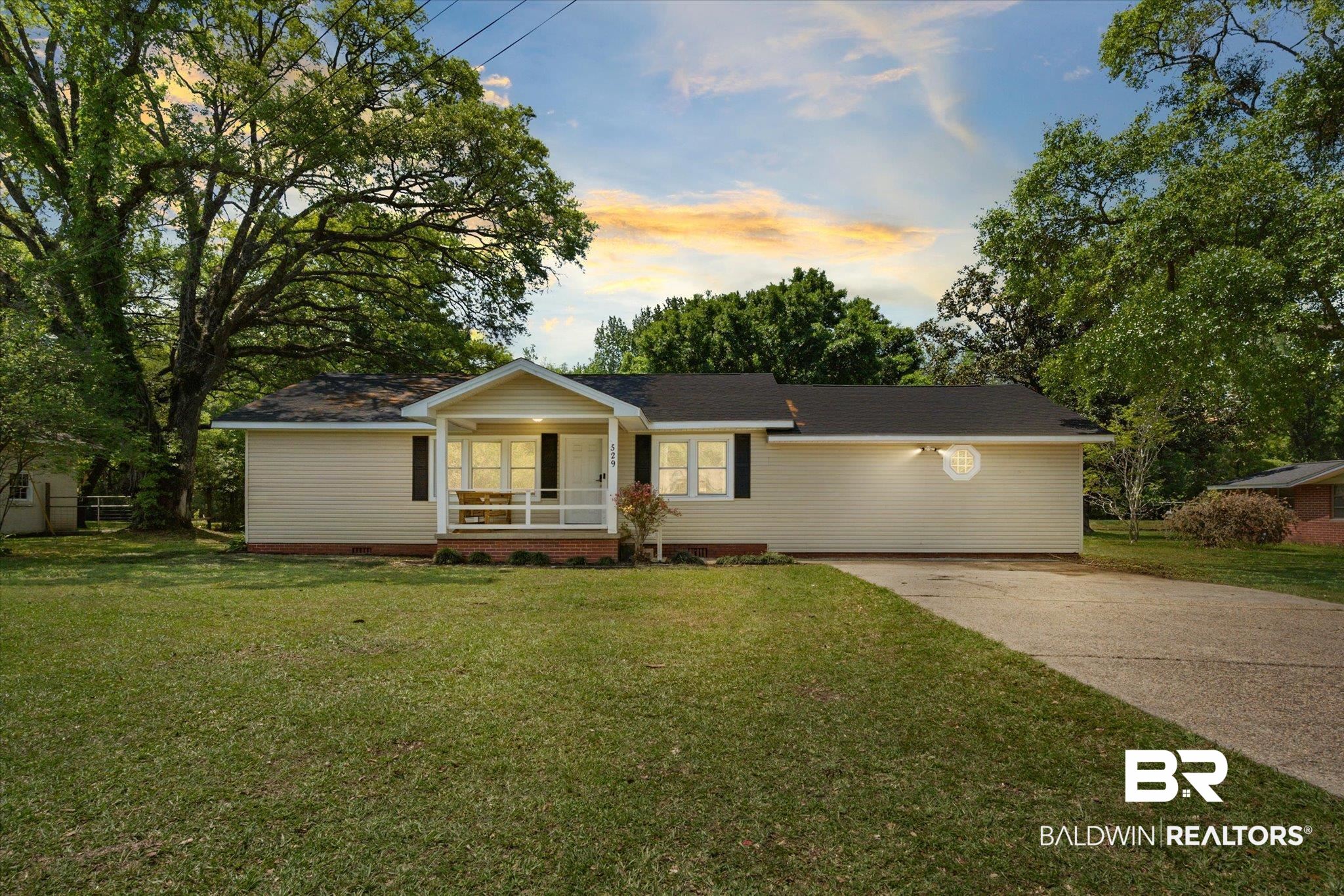 529 Cleveland Road Saraland, AL 36571 - Photo 1 of 31 Ranch-style home featuring a front yard, a porch, and concrete driveway
