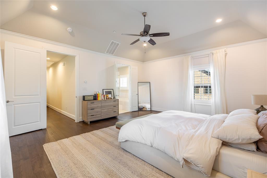 4116 Runyon Road Addison, TX 75001 - Photo 16 of 31 a bedroom with a bed and wooden floor