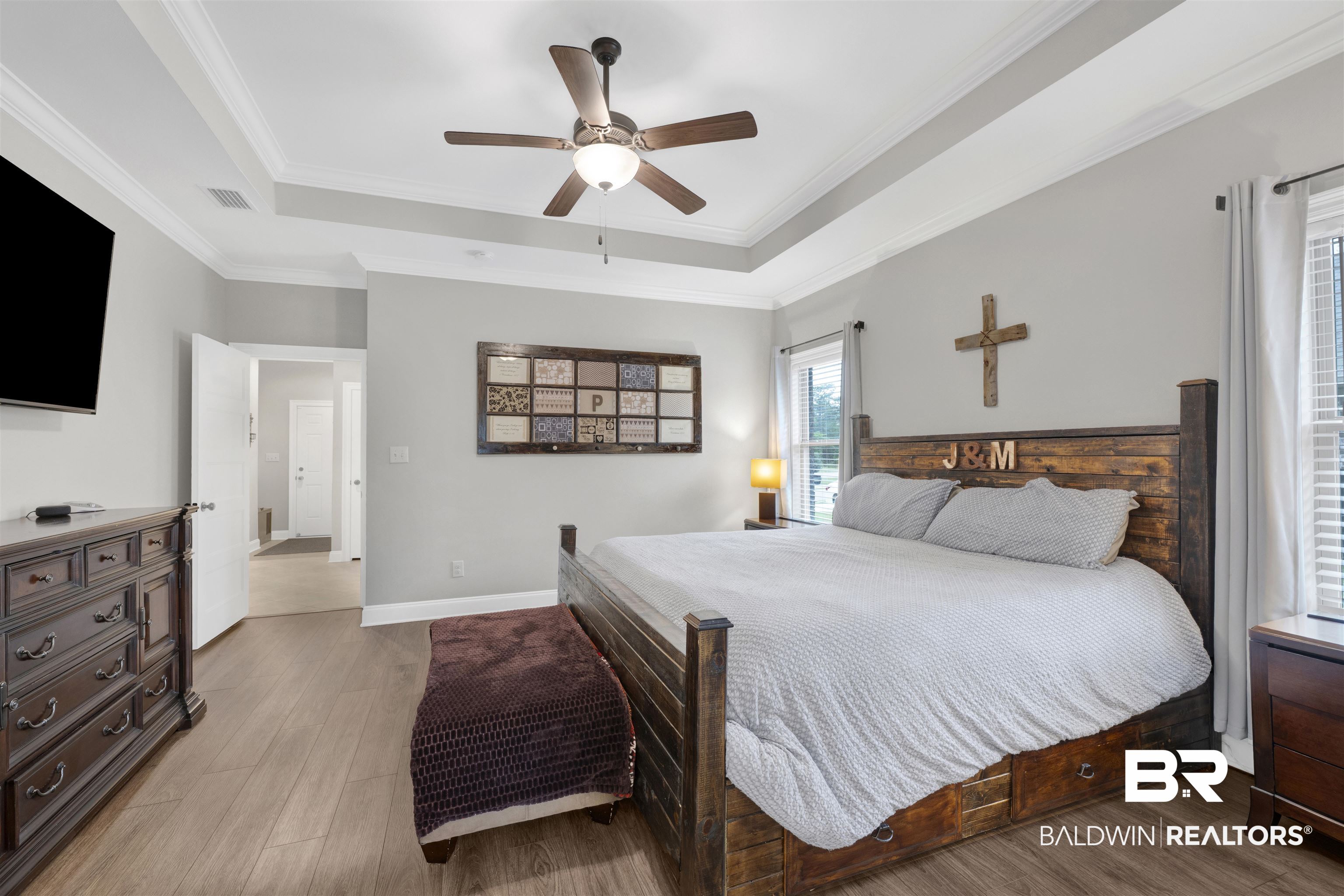 12672 Squirrel Drive Daphne, AL 36527 - Photo 22 of 49 Spacious room featuring wood-finish flooring, light gray walls, and a tray ceiling