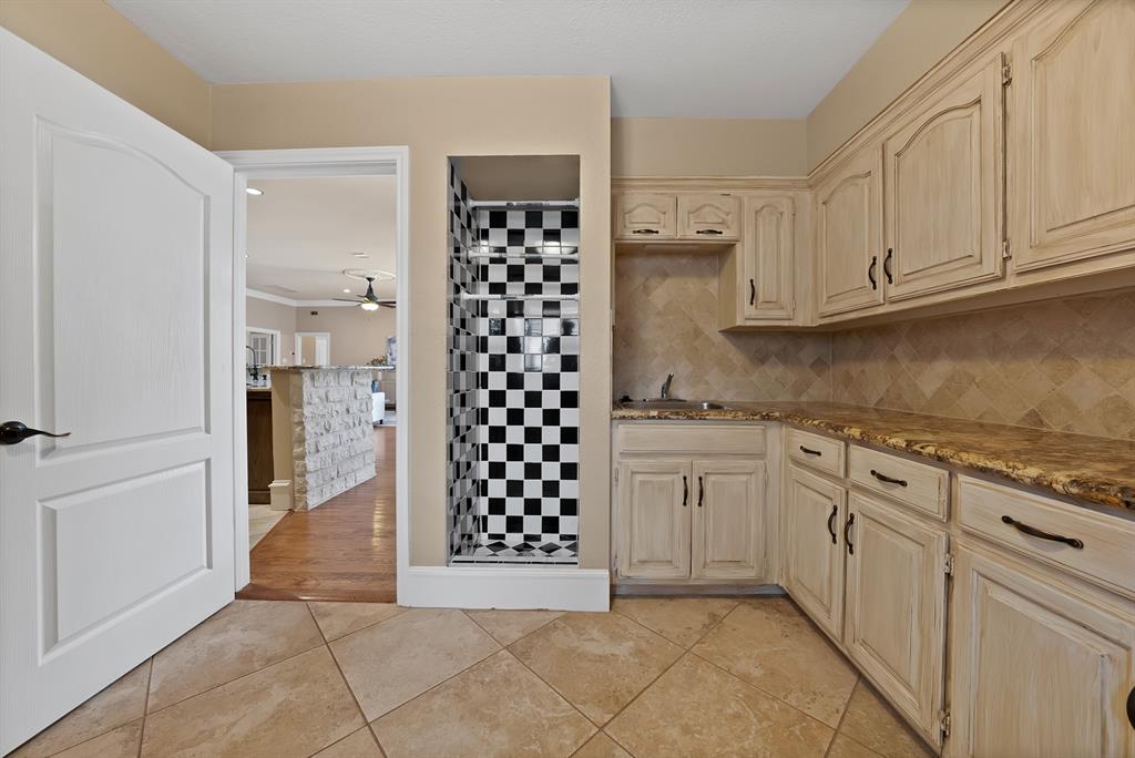 1110 McCampbell Road Mansfield, TX 76063 - Photo 24 of 39 a kitchen with granite countertop white cabinets and appliances
