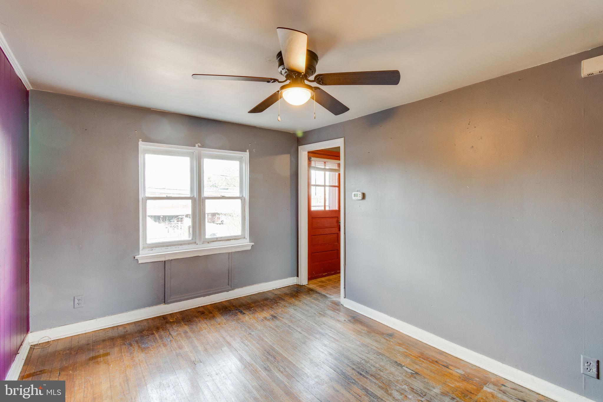 1015 Clark Street Lancaster, PA 17602 - Photo 4 of 14 an empty room with wooden floor fan and windows