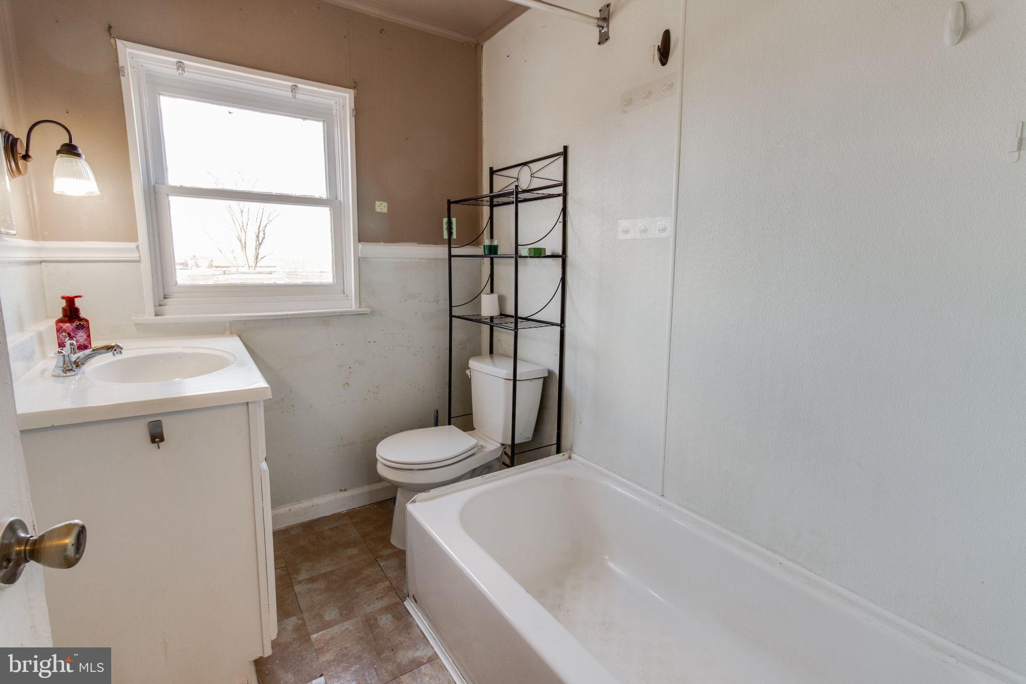 1015 Clark Street Lancaster, PA 17602 - Photo 8 of 14 a bathroom with a sink toilet and window