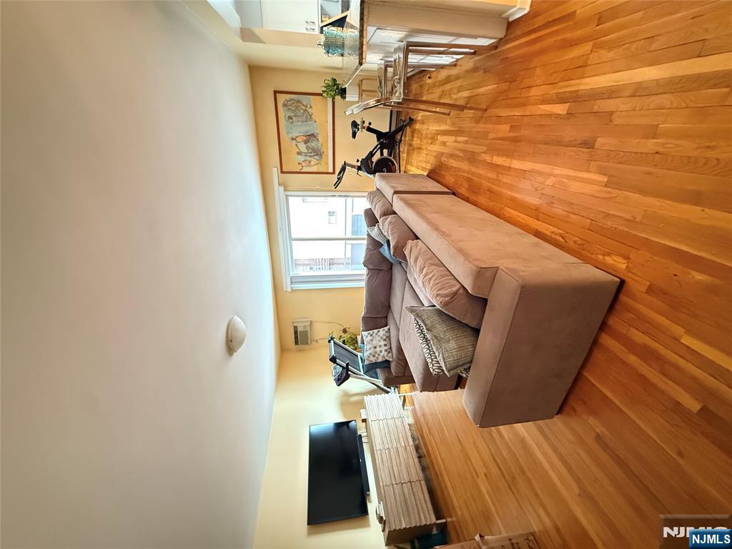 101 Orient Way, Unit 2C1 Rutherford, NJ 07070 - Photo 2 of 12 a living room with furniture and a flat screen tv