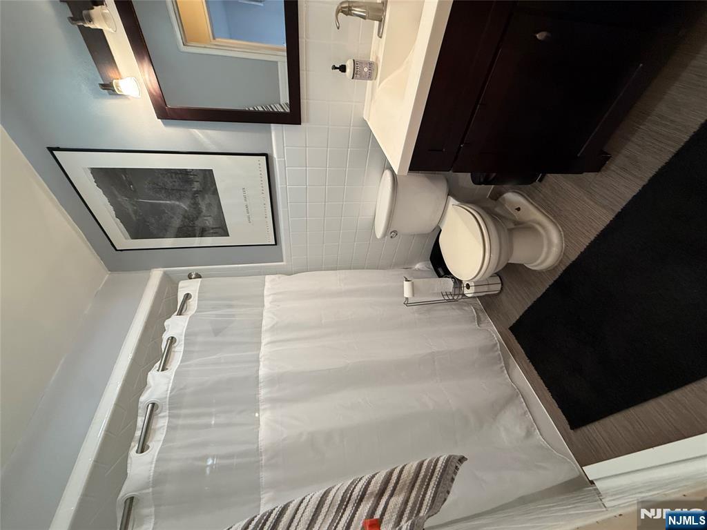 101 Orient Way, Unit 2C1 Rutherford, NJ 07070 - Photo 8 of 12 a bathroom with a sink and a mirror